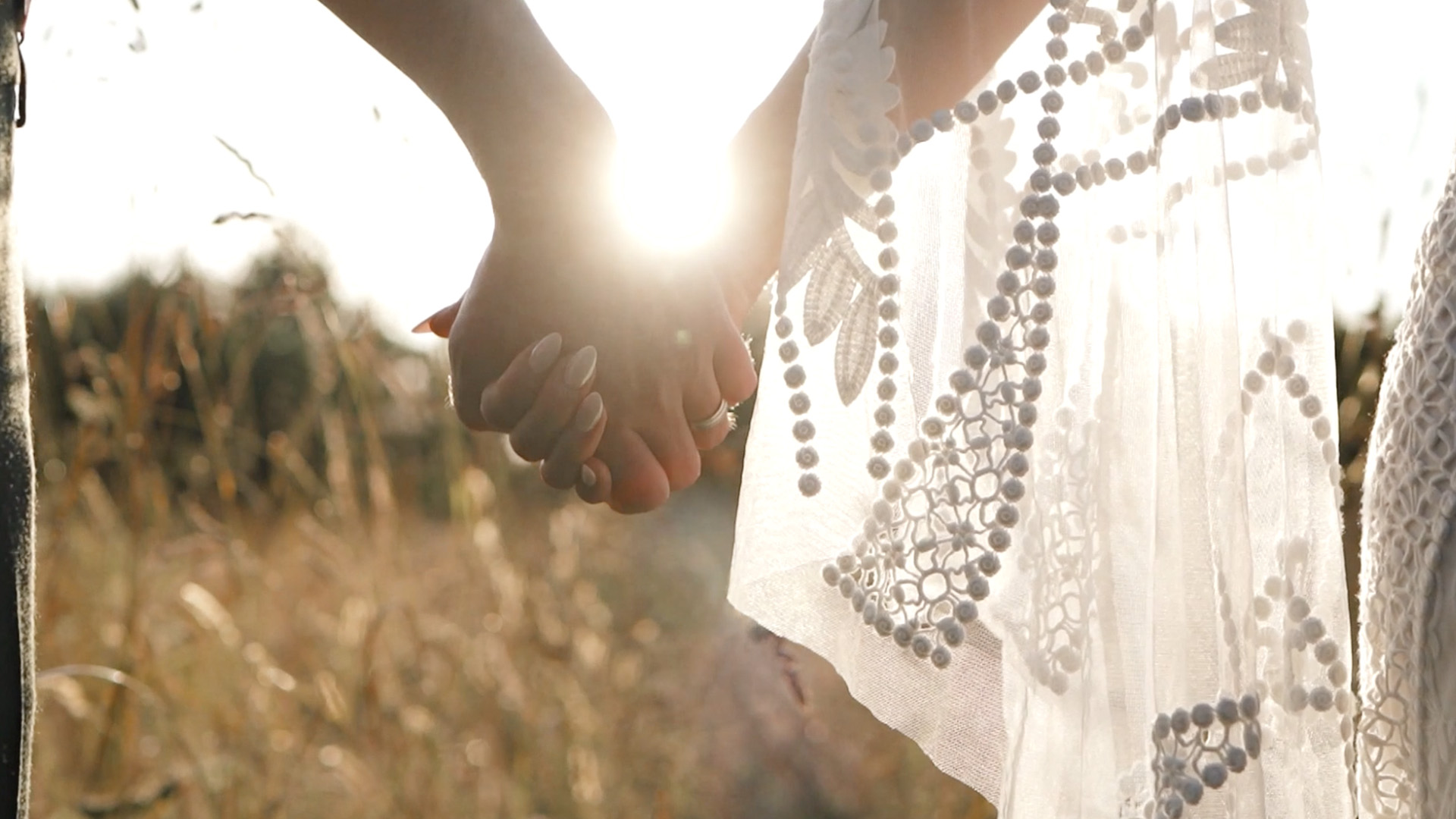Couple holding hands in golden light
